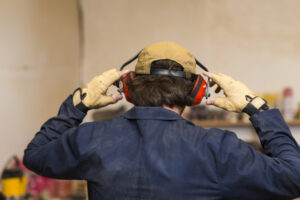 A man with headphones in an industrial setting
