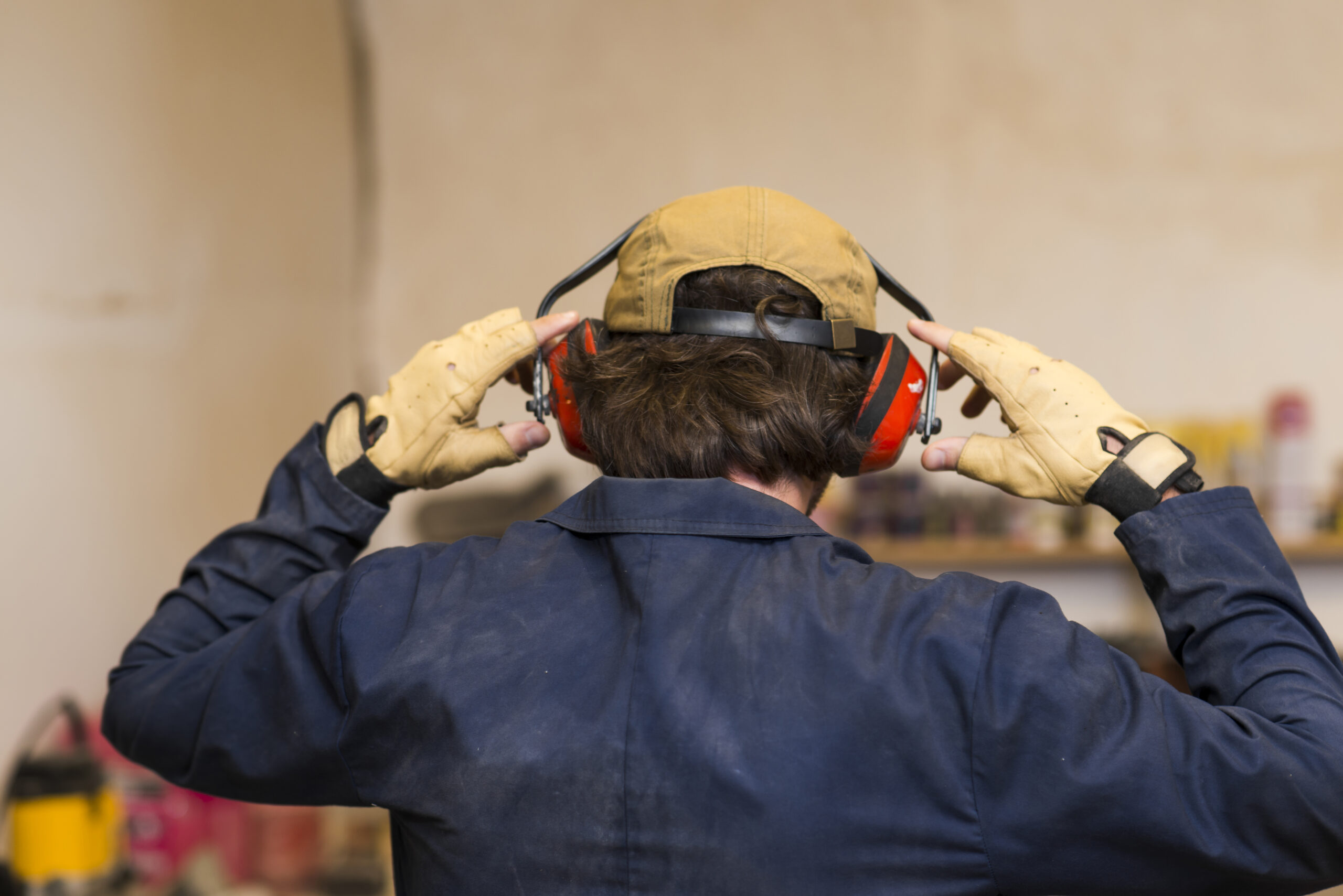 A man with headphones in an industrial setting